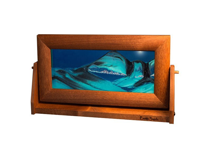 Moving sand art picture in medium alder wood frame with blue liquid & sifting black/white sands on a swivel stand, made in USA.
