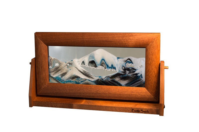 Sandscape Sand Art in an alder wood frame and swivel stand with clear liquid, ever-changing black & white sands accented with blue glitter. Made in USA
