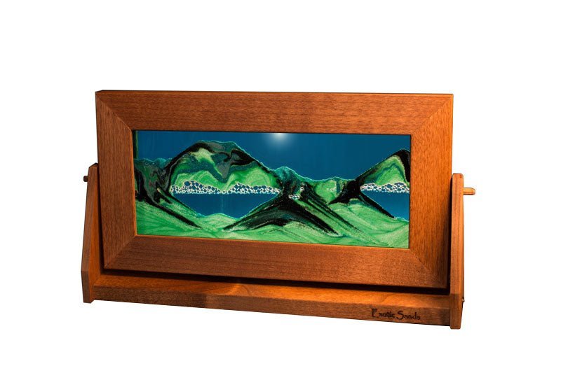 Moving sand art picture in medium alder wood frame with turquoise liquid & black/green sifting sands on a swivel stand, made in USA.