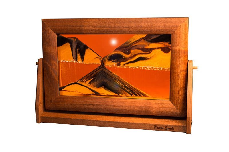 Framed sandscape art titled "Exotic Sands," showcasing shifting sand landscapes encased in glass. Elegant moving sand art.