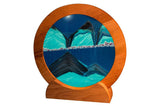 Sand art picture by Exotic Sands USA Round cherry wood frame with green sand and ocean blue liquid