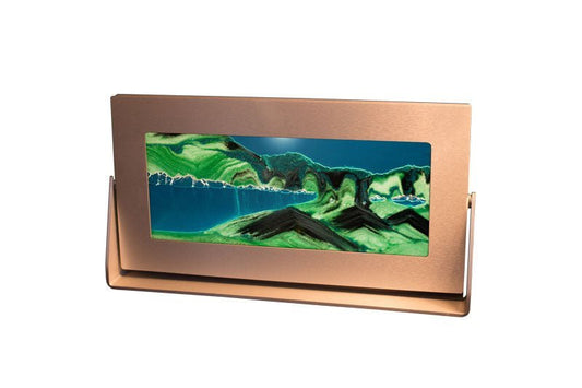 A sifting sandscape art by Exotic Sands in a silver metal frame showcases a mountainous landscape with black and white sands moving sand art pictures